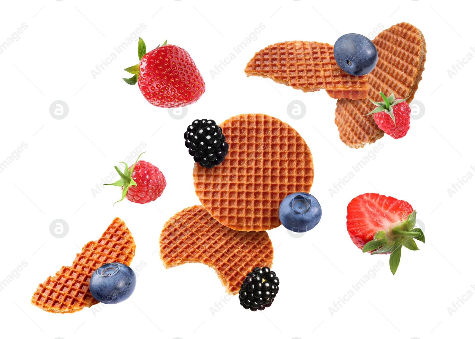Image of Tasty Dutch waffles and fresh berries flying on white background