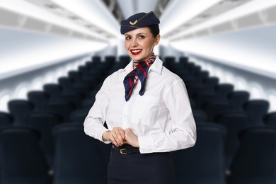 Image of Smiling stewardess in airplane cabin with comfortable seats