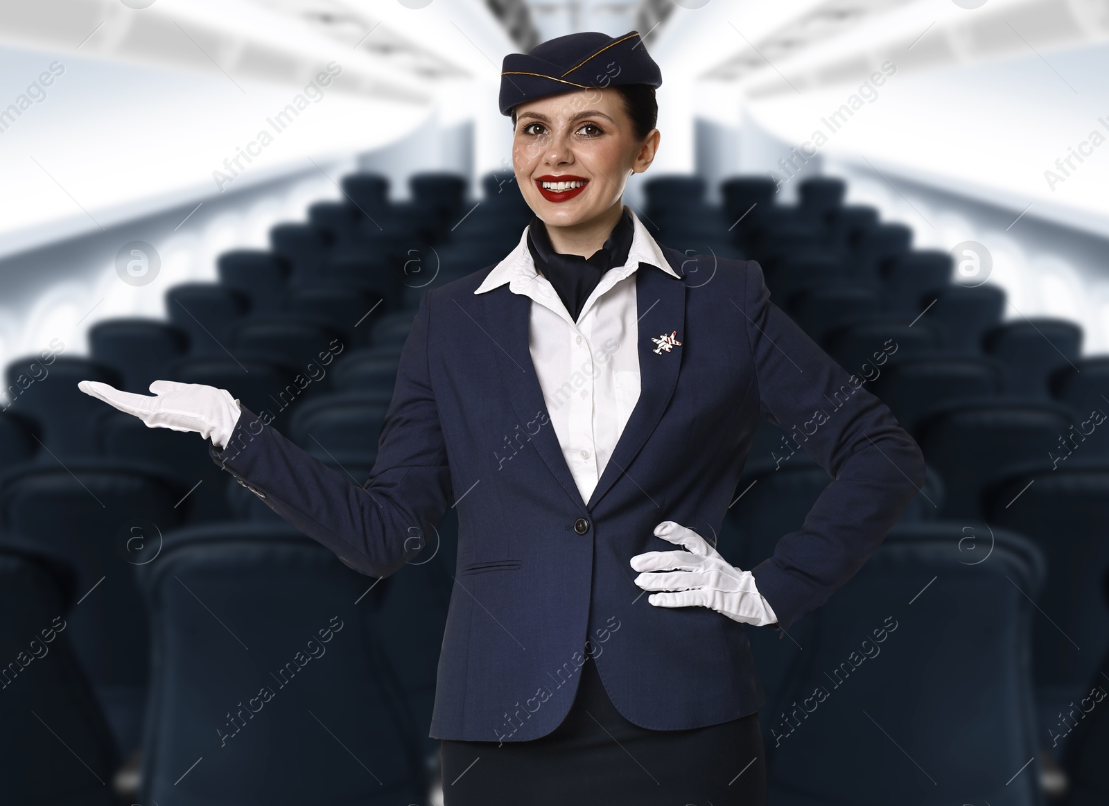 Smiling stewardess welcoming passengers in airplane cabin Image of Smiling stewardess welcoming passengers in airplane cabin