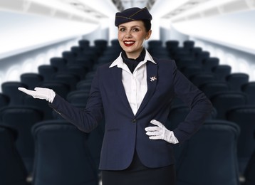 Image of Smiling stewardess welcoming passengers in airplane cabin