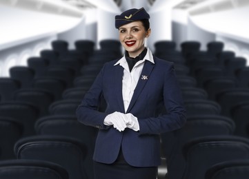 Image of Smiling stewardess in airplane cabin with comfortable seats