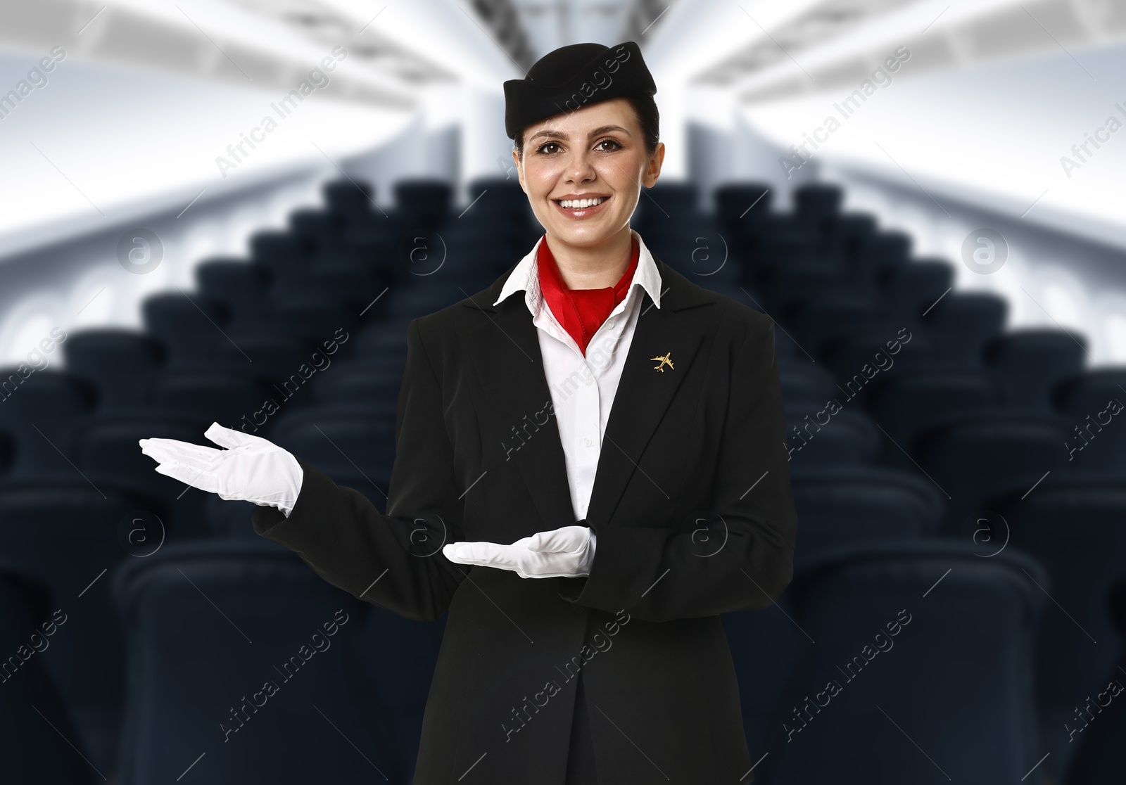 Smiling stewardess welcoming passengers in airplane cabin Image of Smiling stewardess welcoming passengers in airplane cabin