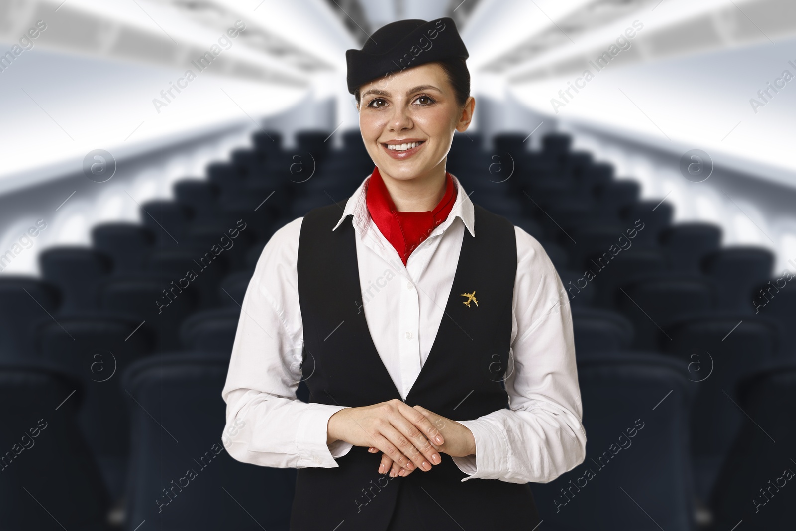 Smiling stewardess in airplane cabin with comfortable seats Image of Smiling stewardess in airplane cabin with comfortable seats