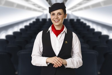 Image of Smiling stewardess in airplane cabin with comfortable seats