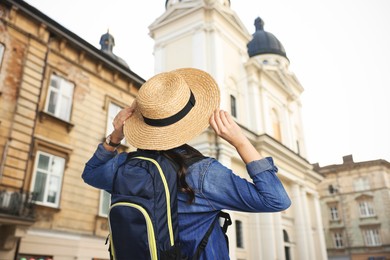 Image of Tourist with backpack on city street, low angle view