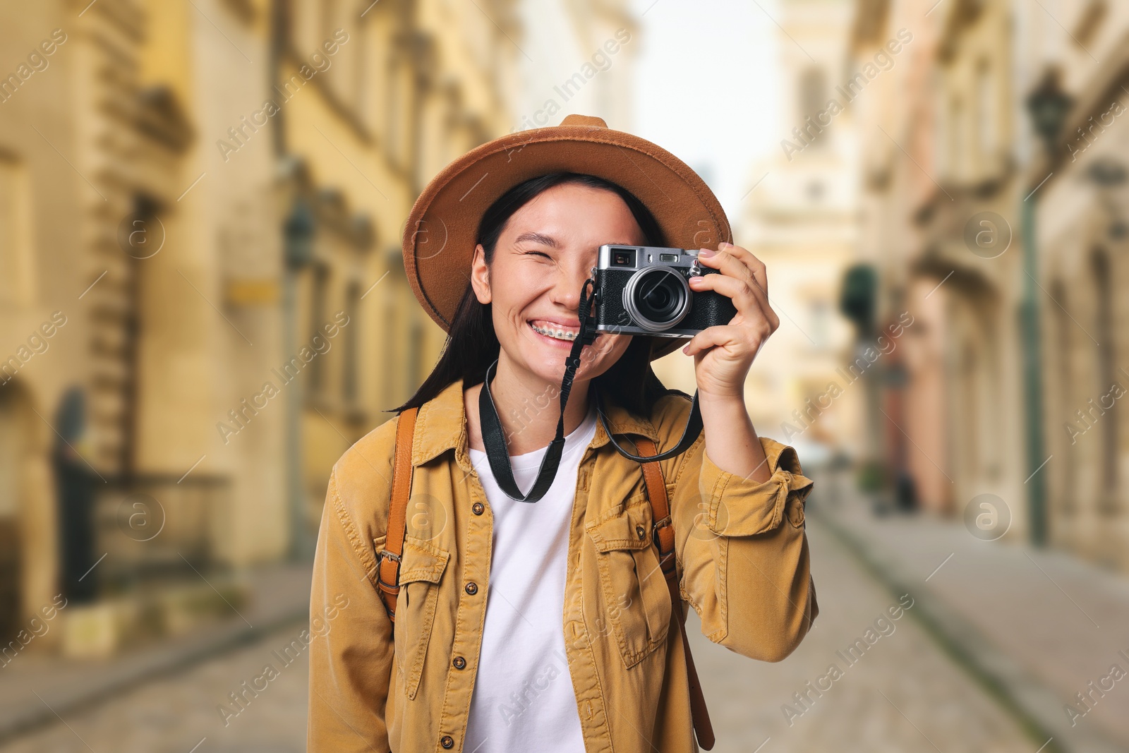 Happy tourist taking photo on city street Image of Happy tourist taking photo on city street