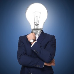 Image of Man with glowing light bulb instead of head on blue background