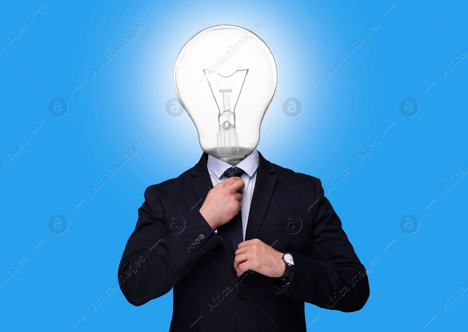 Man with glowing light bulb instead of head on light blue background Image of Man with glowing light bulb instead of head on light blue background