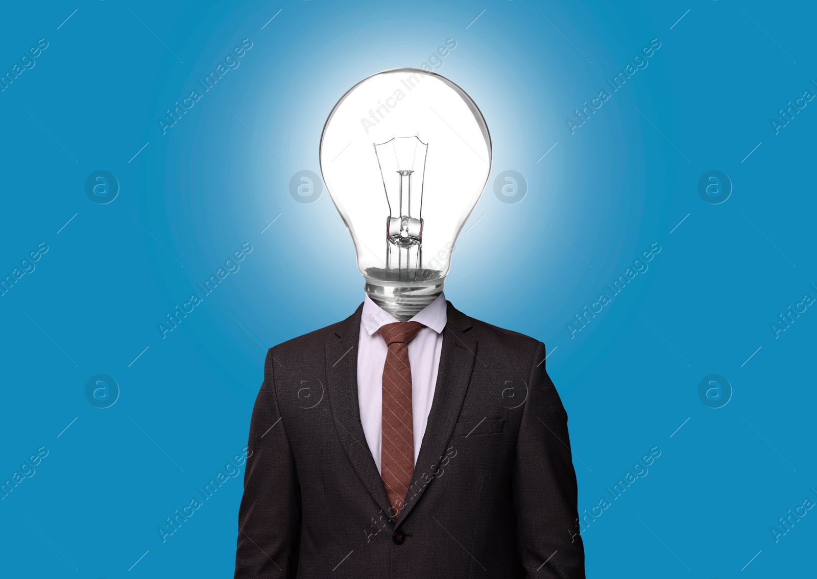 Man with glowing lightbulb instead of head on light blue background Image of Man with glowing lightbulb instead of head on light blue background