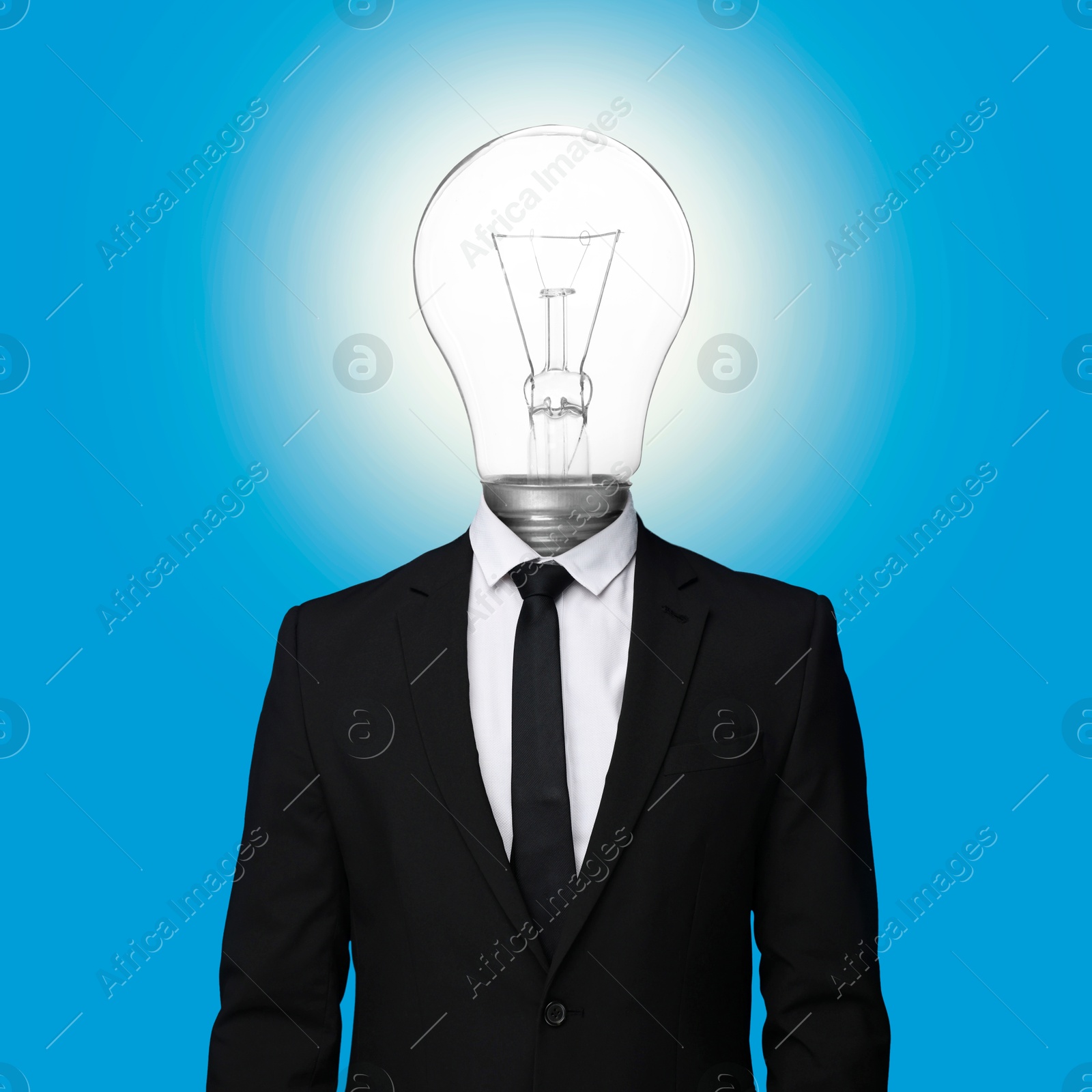 Man with glowing lightbulb instead of head on light blue background Image of Man with glowing lightbulb instead of head on light blue background