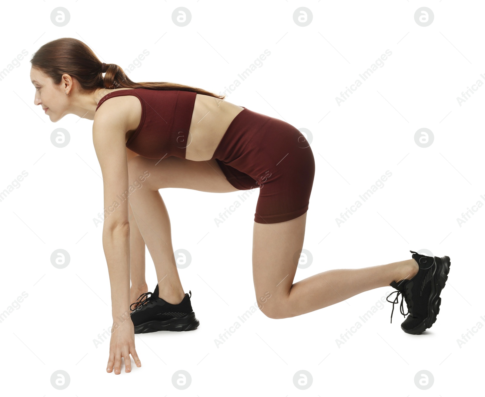 Runner in starting position on white background Photo of Runner in starting position on white background
