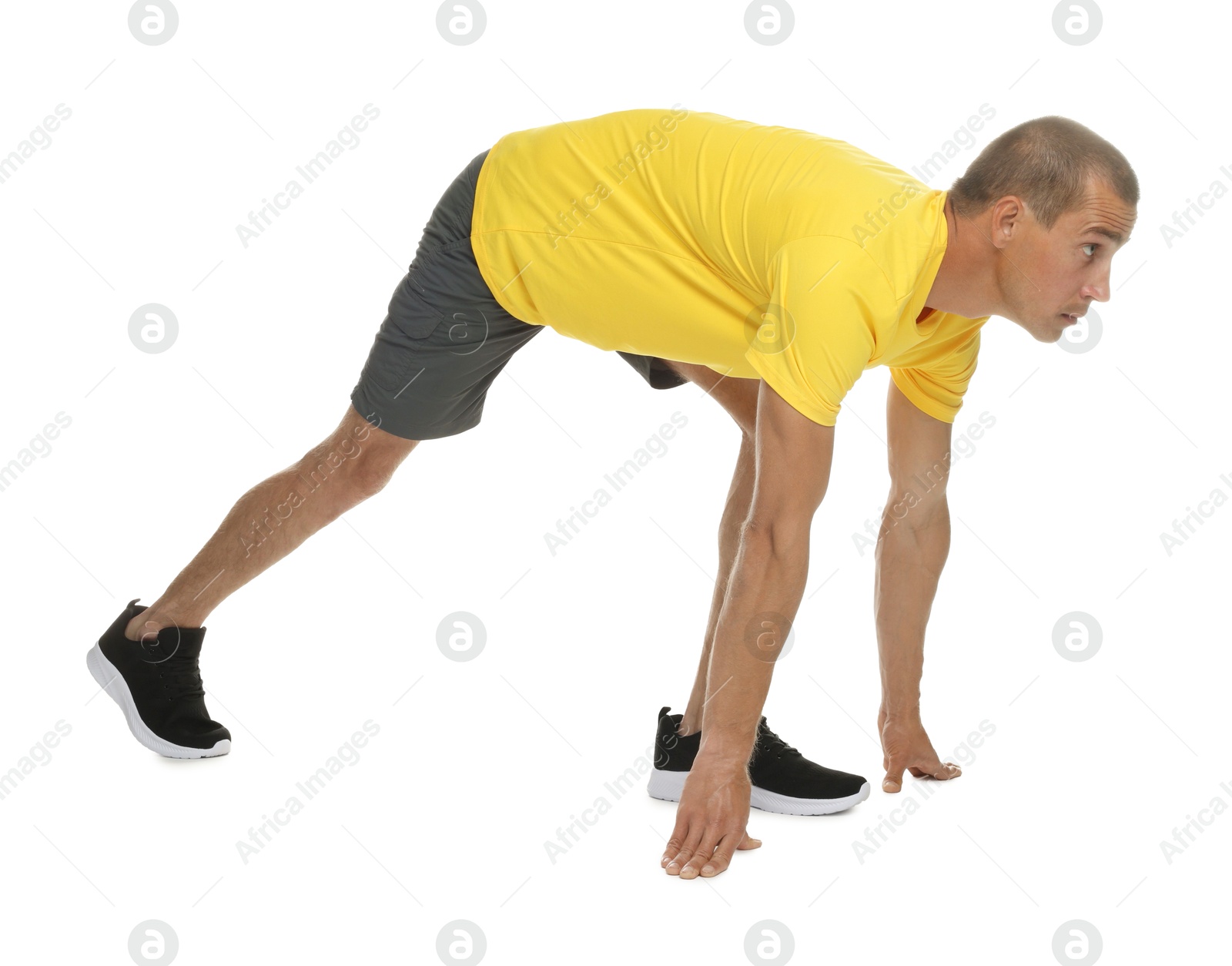 Runner in starting position on white background Photo of Runner in starting position on white background
