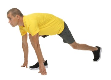 Photo of Runner in starting position on white background