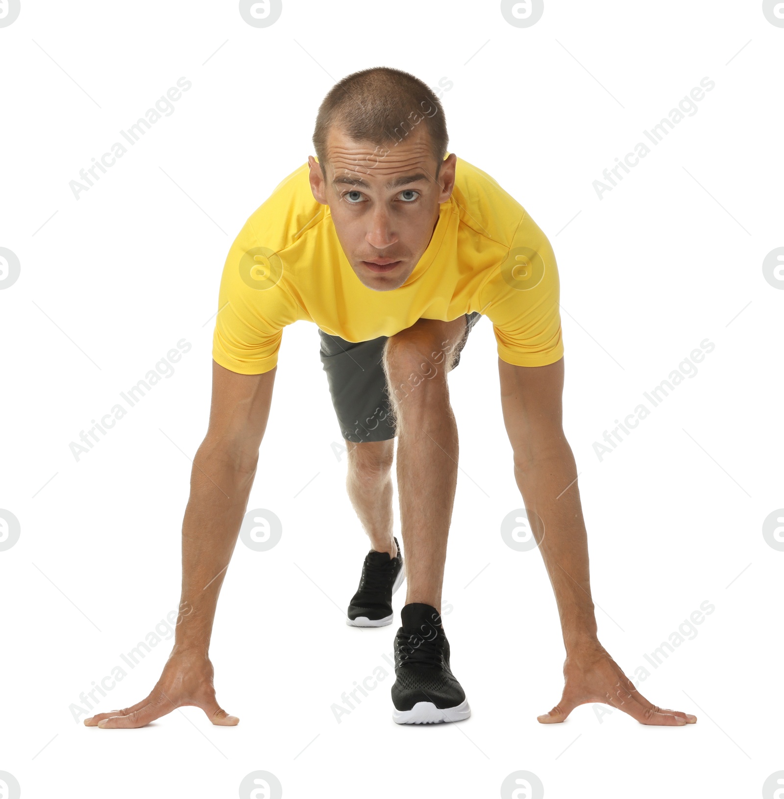 Runner in starting position on white background Photo of Runner in starting position on white background
