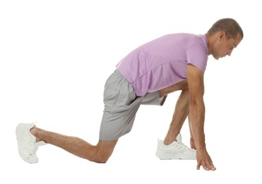 Photo of Runner in starting position on white background