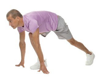 Photo of Runner in starting position on white background