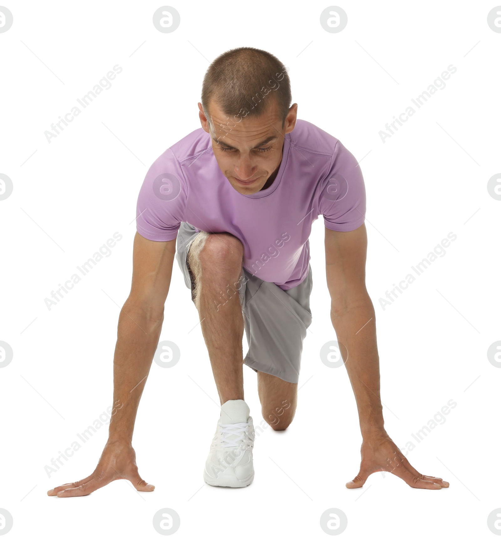 Runner in starting position on white background Photo of Runner in starting position on white background