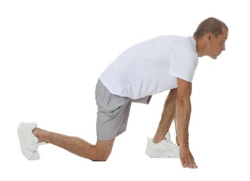 Photo of Runner in starting position on white background