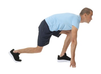 Photo of Runner in starting position on white background