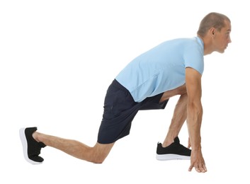 Photo of Runner in starting position on white background