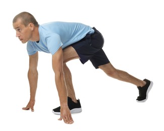 Photo of Runner in starting position on white background