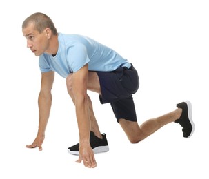Photo of Runner in starting position on white background