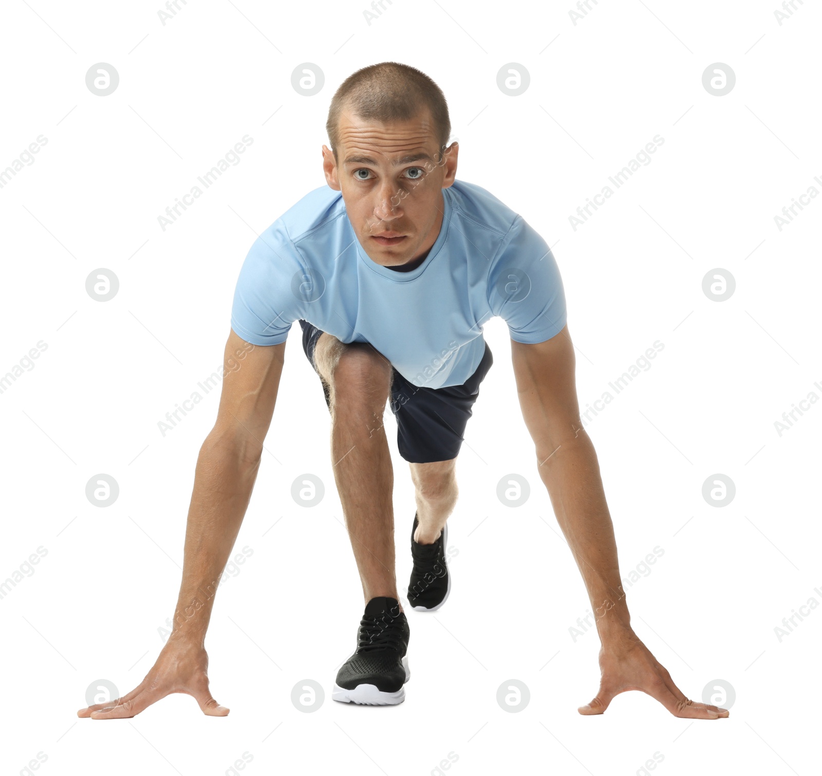 Runner in starting position on white background Photo of Runner in starting position on white background