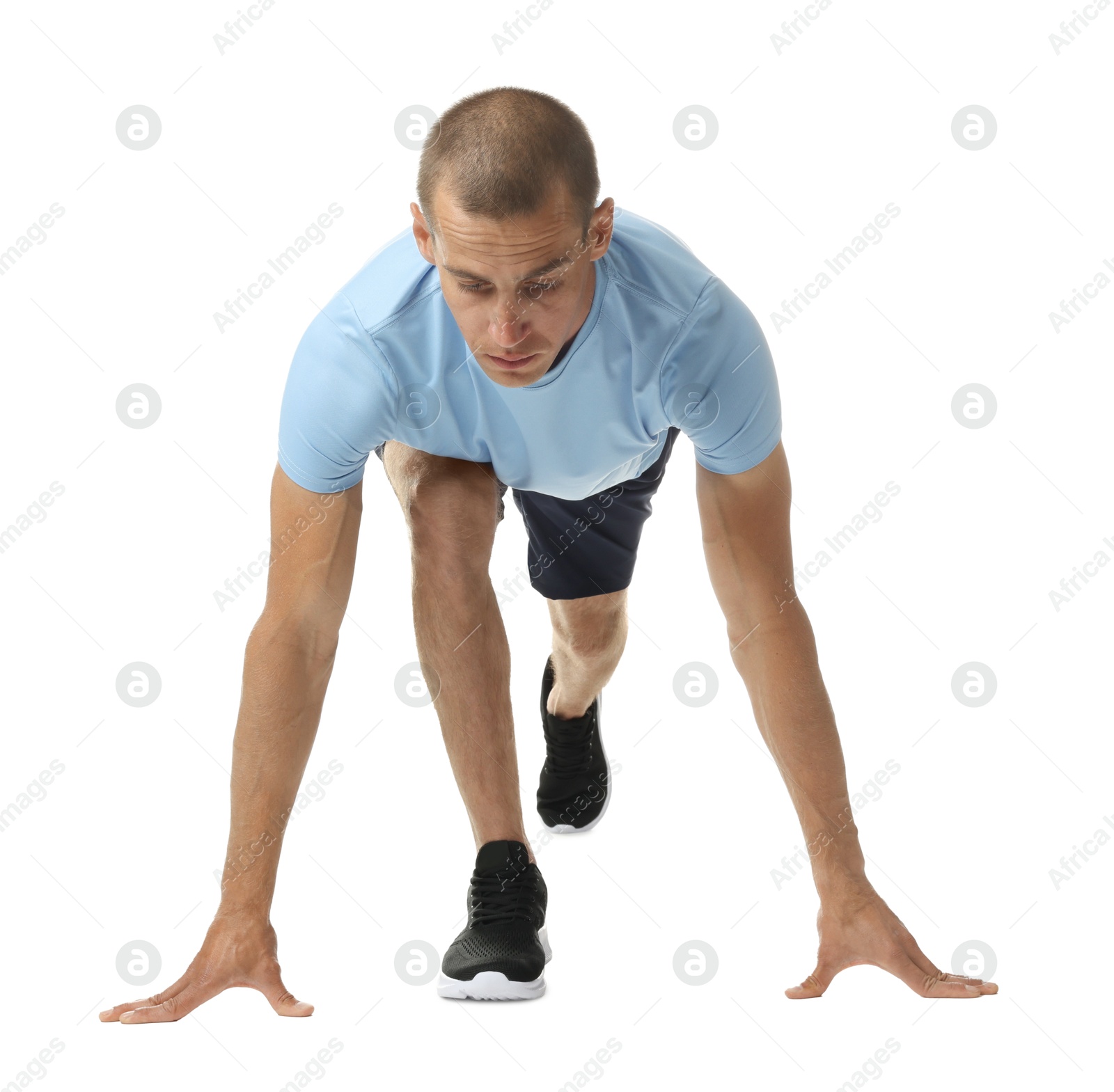 Runner in starting position on white background Photo of Runner in starting position on white background