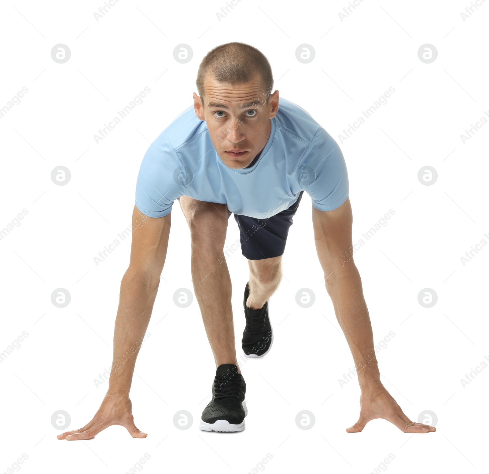 Runner in starting position on white background Photo of Runner in starting position on white background