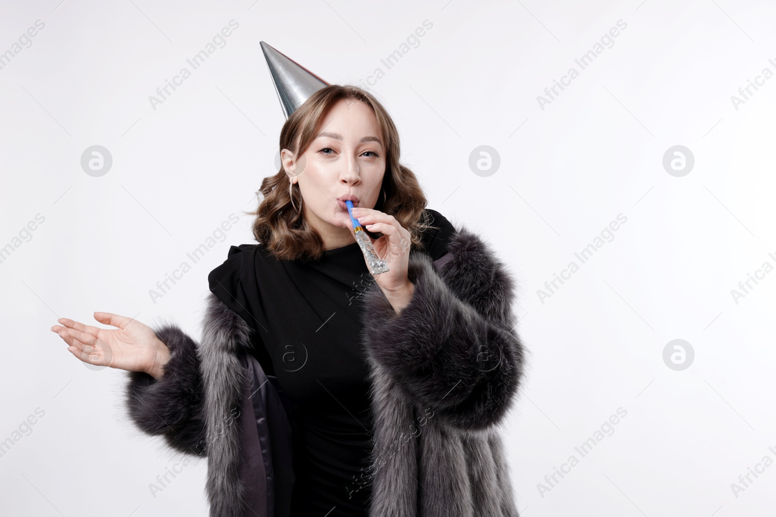 Birthday celebration. Woman with party horn on white background. Space for text Photo of Birthday celebration. Woman with party horn on white background. Space for text