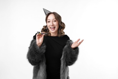 Photo of Birthday celebration. Woman with party horn on white background