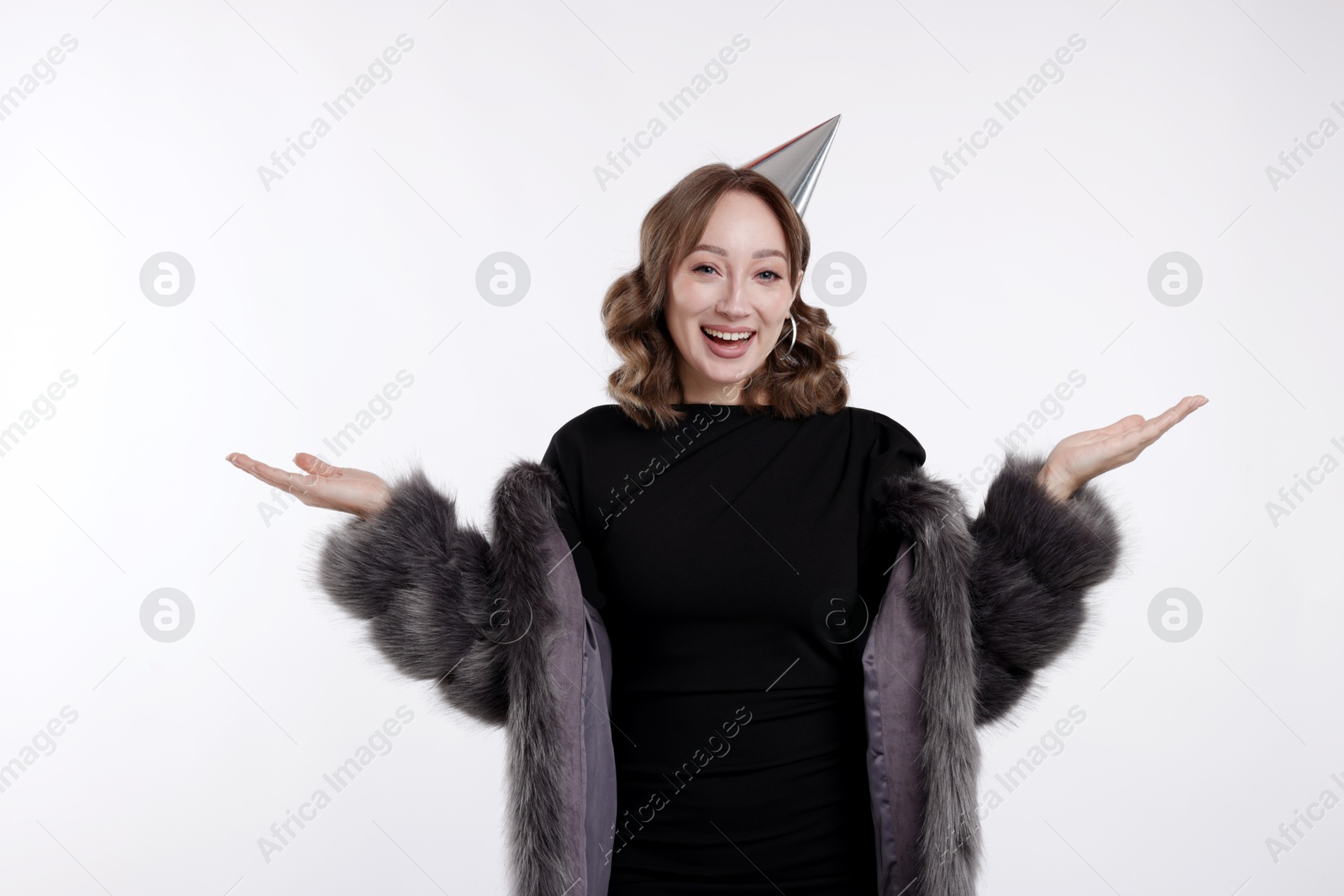 Birthday celebration. Happy woman with party cone on white background Photo of Birthday celebration. Happy woman with party cone on white background