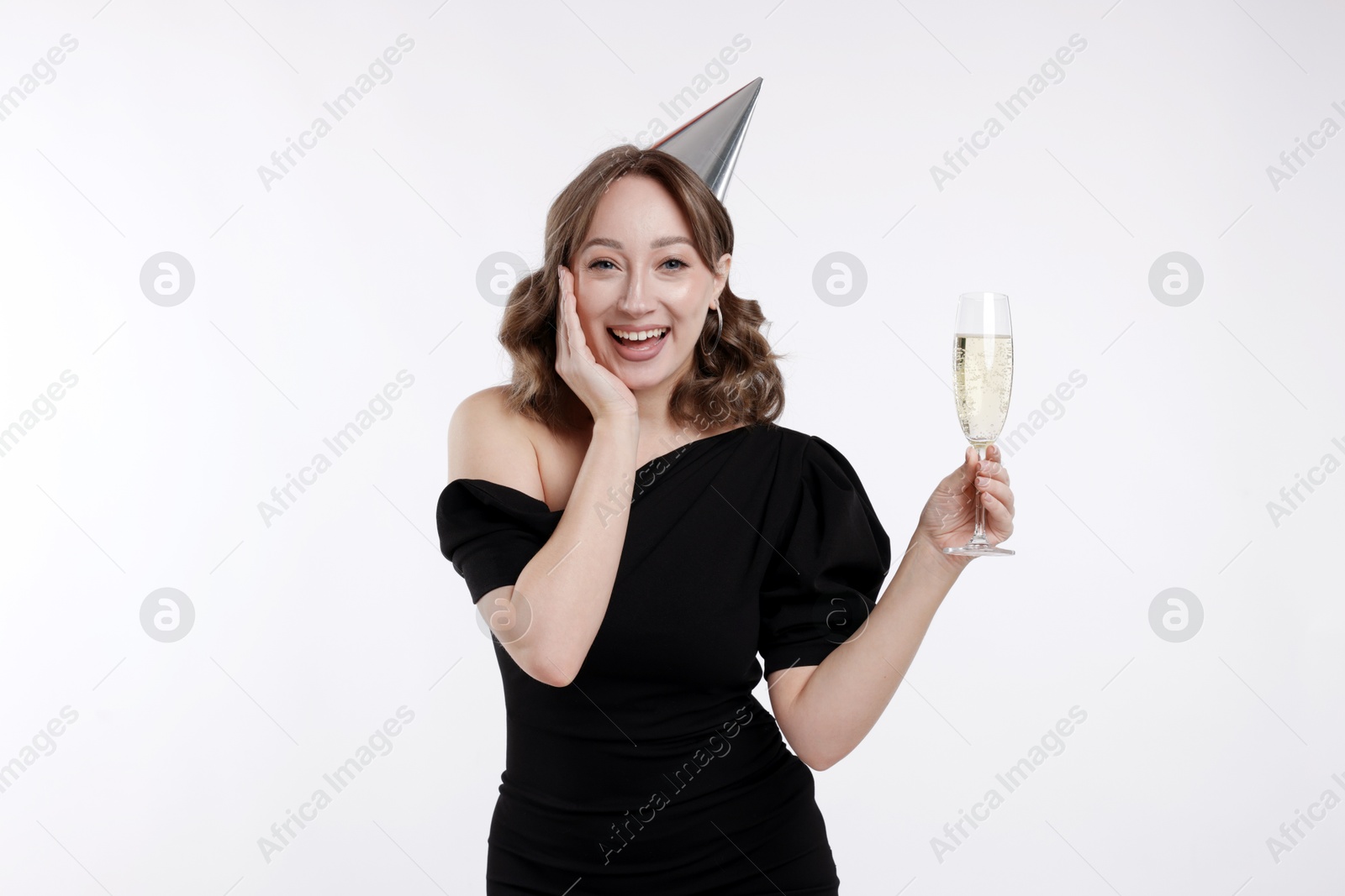 Birthday celebration. Woman with glass of sparkling wine on white background Photo of Birthday celebration. Woman with glass of sparkling wine on white background