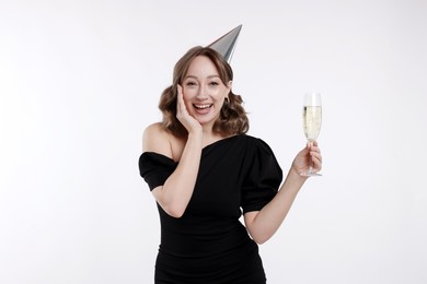 Photo of Birthday celebration. Woman with glass of sparkling wine on white background