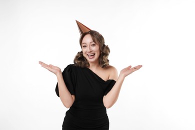 Photo of Birthday celebration. Woman with party cone and confetti on white background