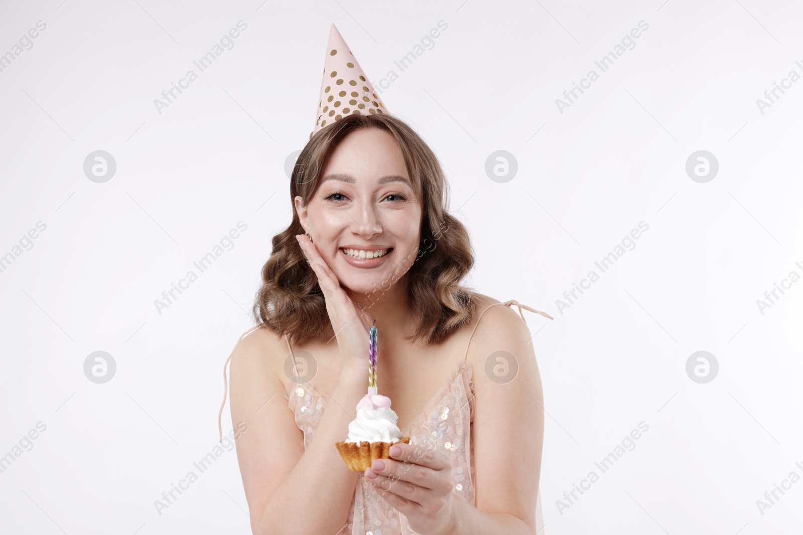 Birthday celebration. Woman with cupcake on white background Photo of Birthday celebration. Woman with cupcake on white background