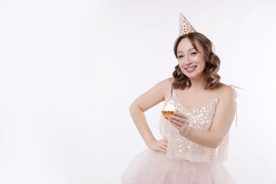 Photo of Birthday celebration. Woman with cupcake on white background. Space for text