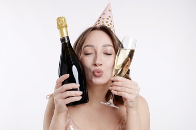 Photo of Birthday celebration. Woman with sparkling wine on white background