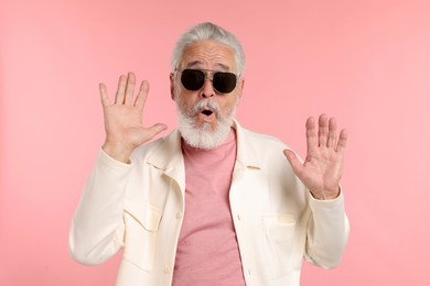 Photo of Elderly man in stylish outfit on pink background