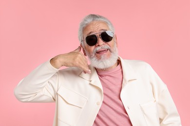 Photo of Elderly man in stylish outfit on pink background