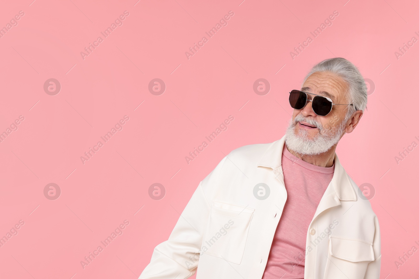 Elderly man in stylish outfit on pink background, space for text Photo of Elderly man in stylish outfit on pink background, space for text