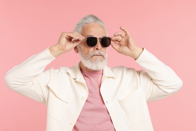 Photo of Elderly man in stylish outfit on pink background