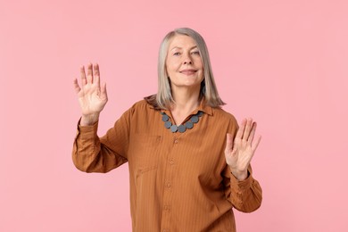 Photo of Senior woman in stylish outfit on pink background
