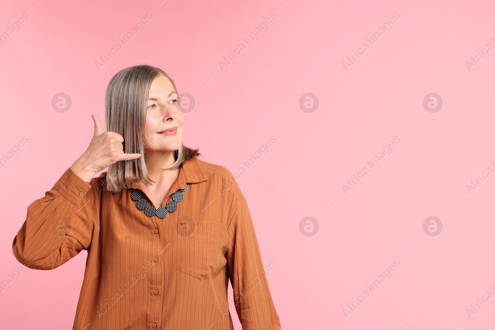 Senior woman in stylish outfit on pink background, space for text Photo of Senior woman in stylish outfit on pink background, space for text