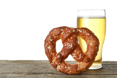 Photo of Tasty pretzel and glass of beer on wooden table against white background. Space for text