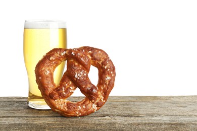 Photo of Tasty pretzel and glass of beer on wooden table against white background. Space for text