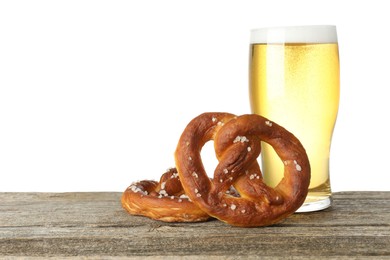 Photo of Tasty pretzels and glass of beer on wooden table against white background. Space for text