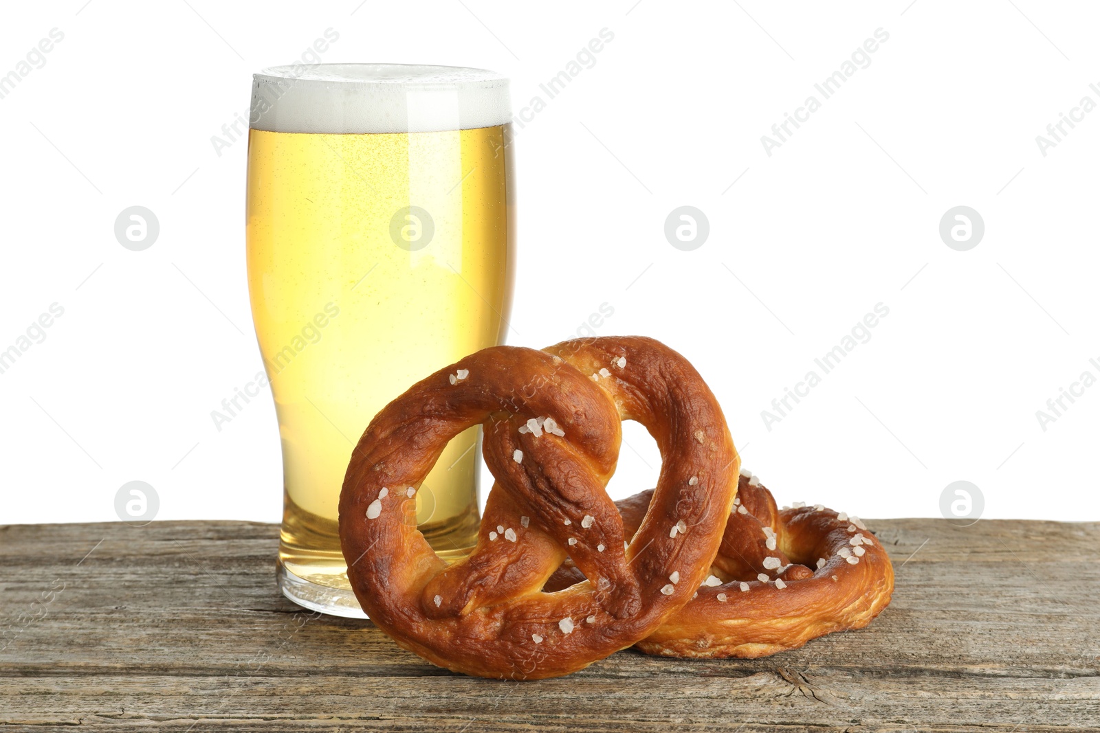 Tasty pretzels and glass of beer on wooden table against white background Photo of Tasty pretzels and glass of beer on wooden table against white background