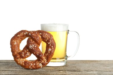 Photo of Tasty pretzel and glass of beer on wooden table against white background. Space for text