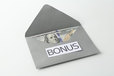 Photo of Envelope with word Bonus and dollar banknotes isolated on white